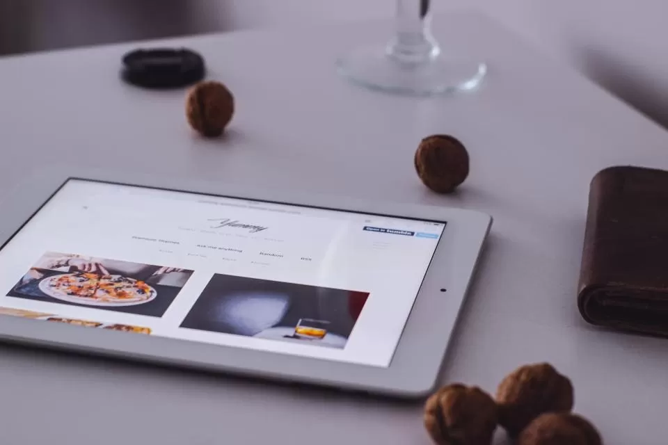 A tablet on a table showing a website
